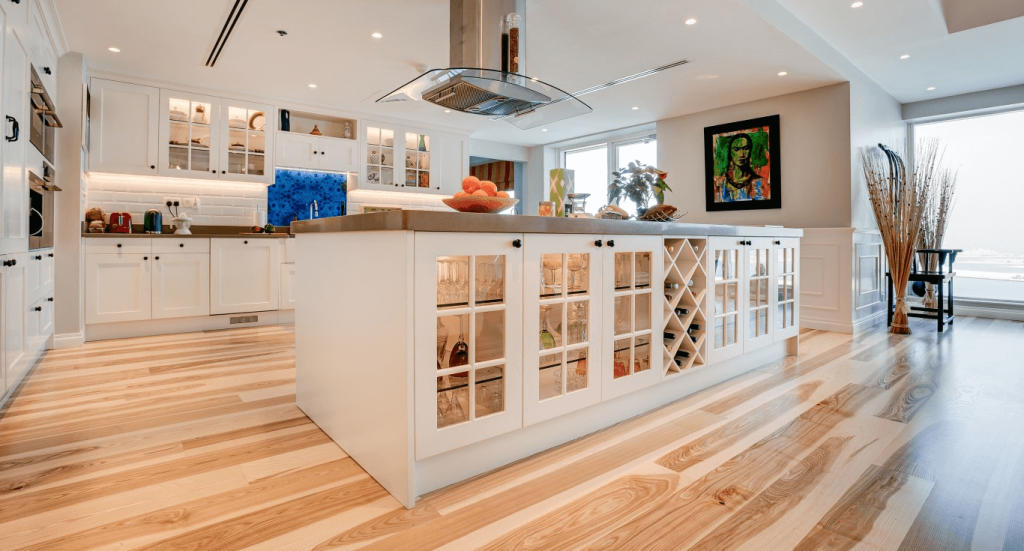 Kitchen interior in Dubai Marina, featuring bold Kährs wood kitchen flooring as the focal point of the space by Nordic Homeworx.