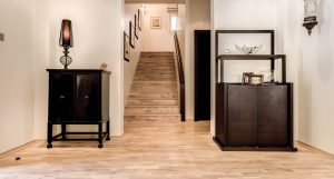 Oak Dew flooring extends from the entrance hall to the staircase within this Hattan Villa. 