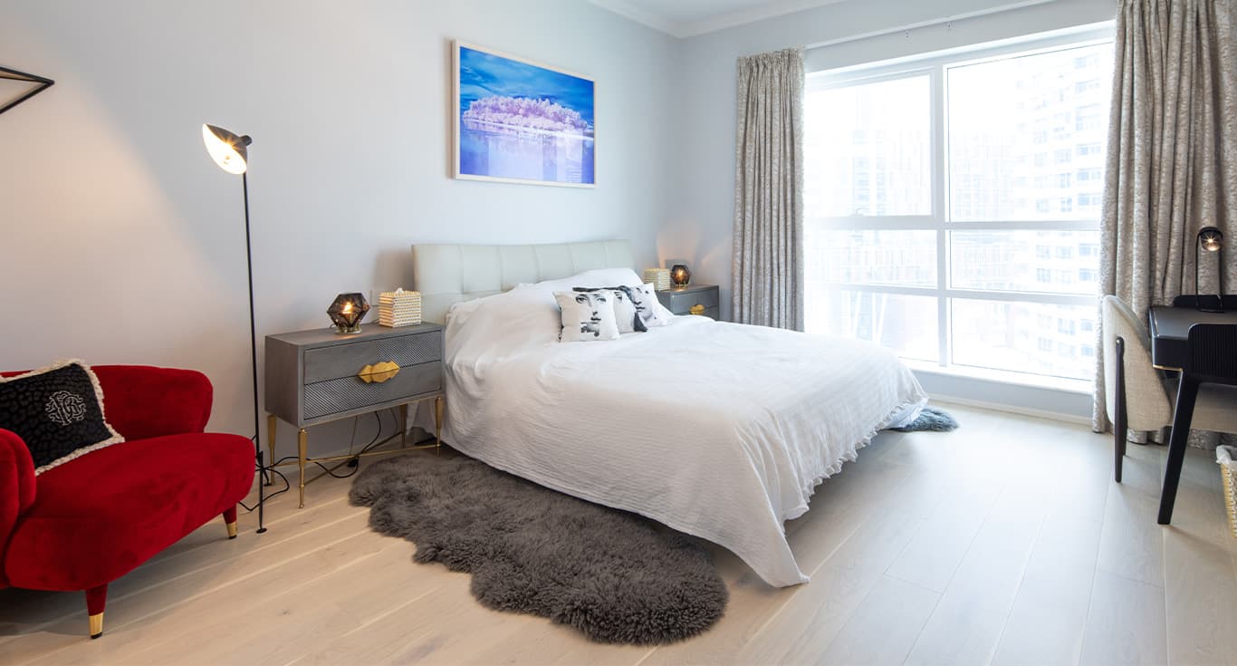 A cozy bedroom at a private apartment in Marina Quays