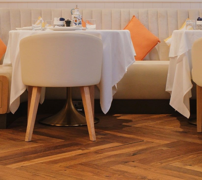 Scalini Cucina in The Dubai Mall with tables and chairs complementing the dark wood floor, by Nordic Homeworx