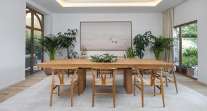 Hattan Villa The Lakes light oak flooring paired with a neutral carpet layered to define the dining zone
