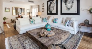 The Meadows Villa Meadows 9 Oak Tramonto flooring paired with a layered carpet to define the seating layout 