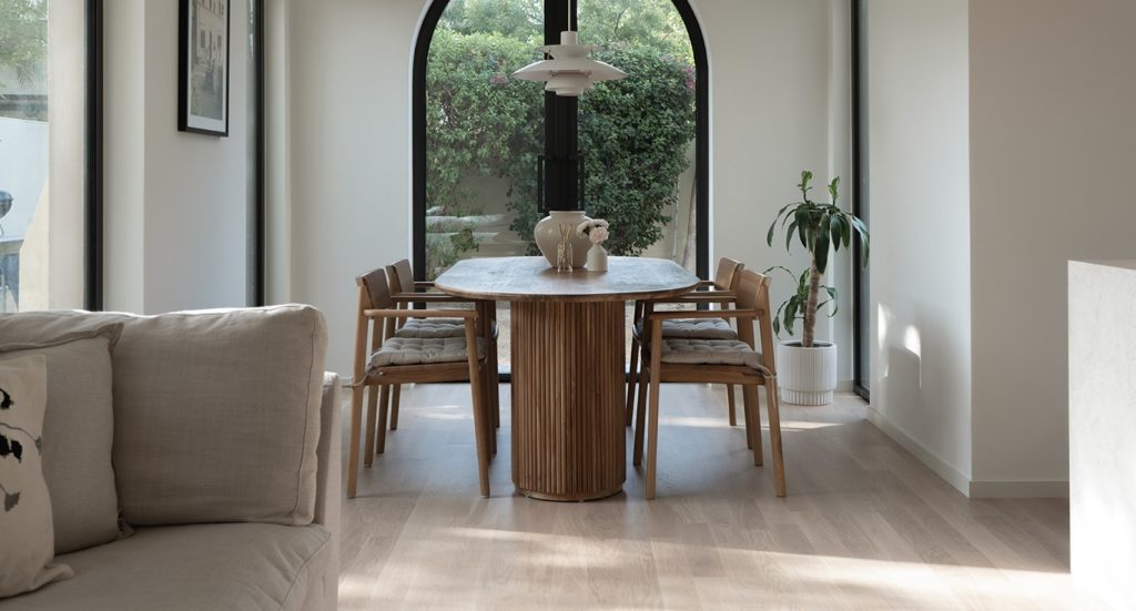At Springs Townhouse in Dubai, in a minimalist interior design in the dining area, with classic wood flooring by Nordic Homeworx.