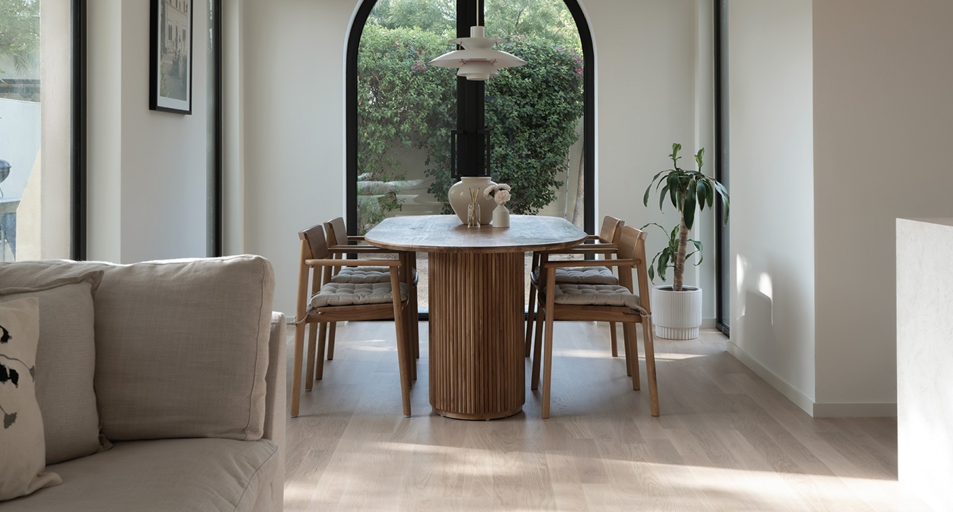 At Springs Townhouse in Dubai, in a minimalist interior design in the dining area, with classic wood flooring by Nordic Homeworx.