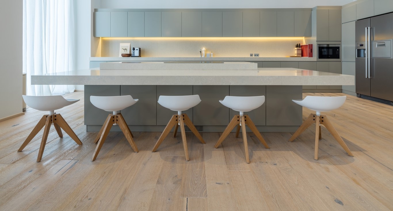 Minimalist interior design in the kitchen of Cayan Tower Apartment, Dubai Marina, featuring light wood flooring by Nordic Homeworx