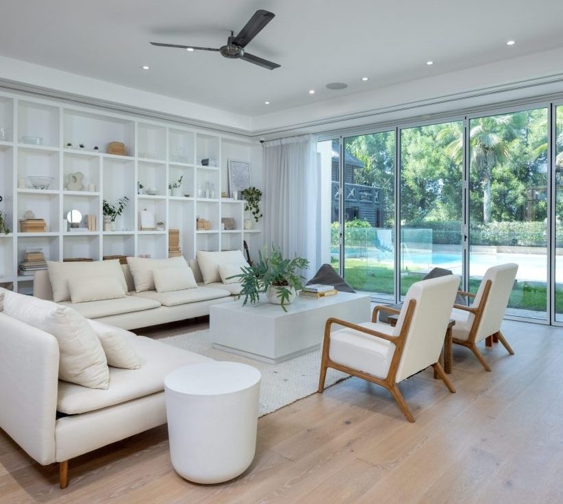 Hattan Villa, The Lakes, Dubai, featuring a minimalist living room with vinyl tiles and pool views by Nordic Homeworx.