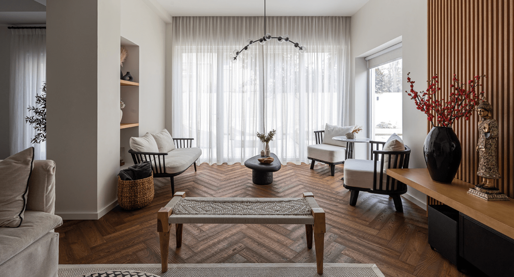 A cosy living room with wood parquet flooring by Nordic Homeworx in Dubai featuring Herringbone Oak showcasing warmth and texture.