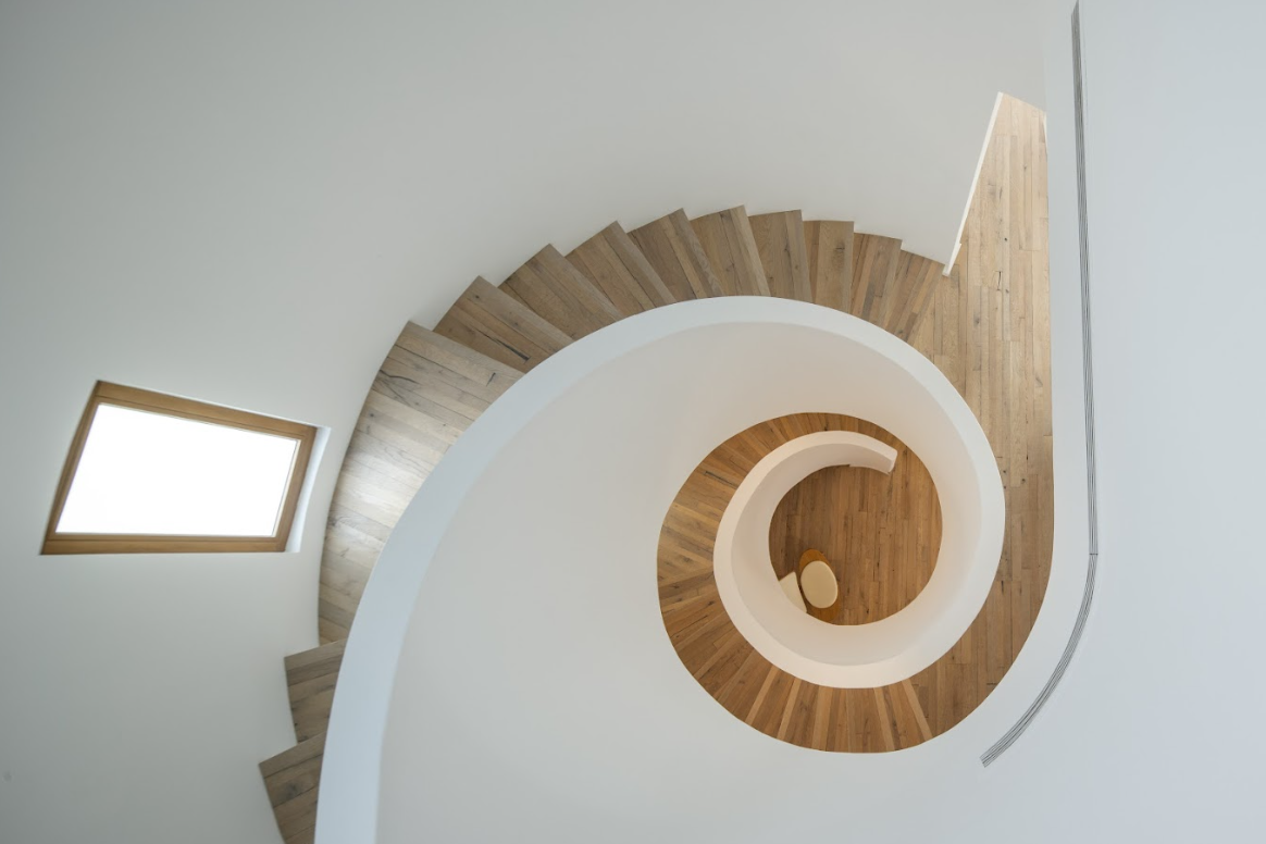 Perfectly installed Kährs oak wood flooring on a spiral staircase at Hattan villa in The Lakes by Nordic Homeworx