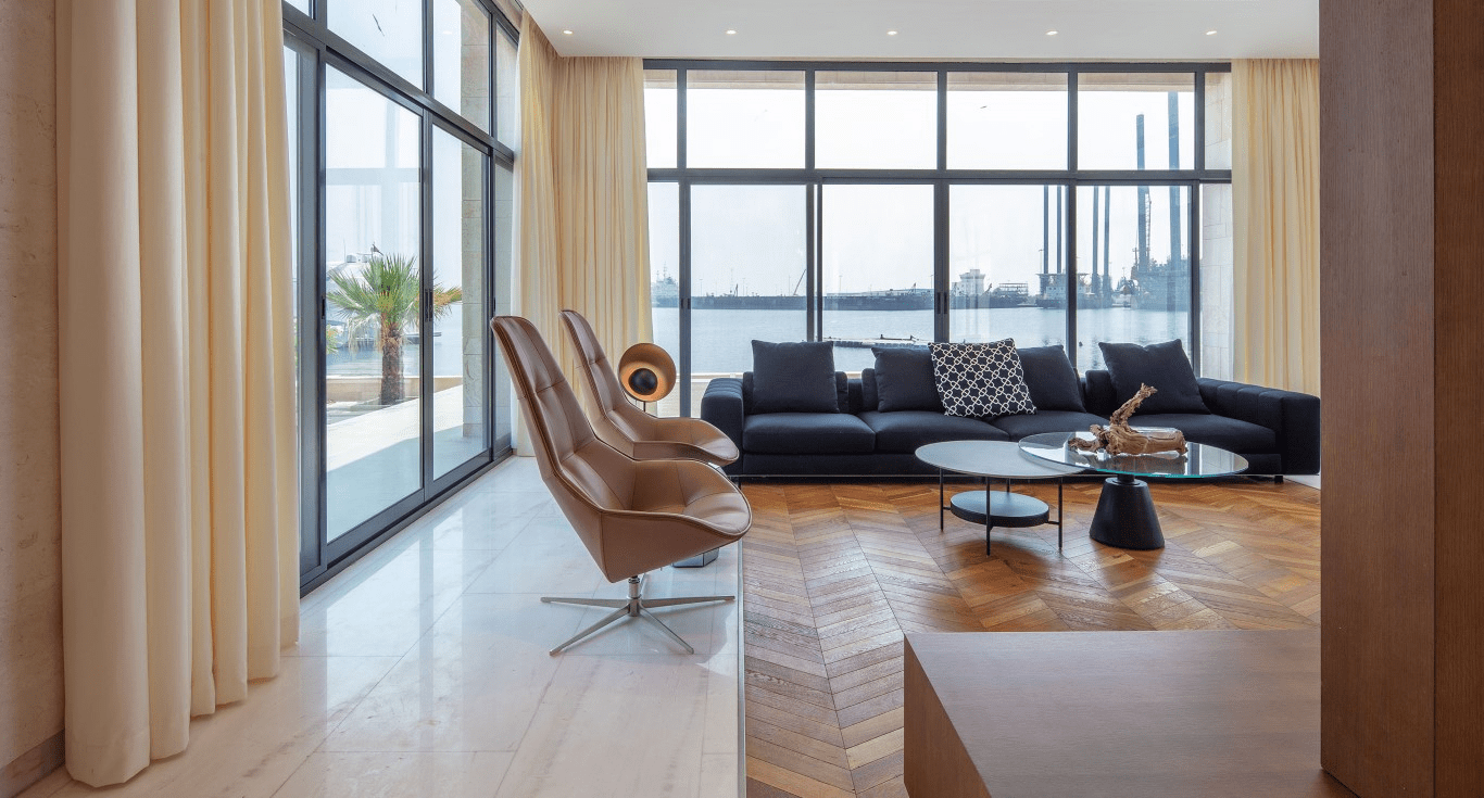 A Living room featuring Oak Chevron Light Brown parquet flooring by Nordic Homeworx, creating a warm and contemporary interior.
