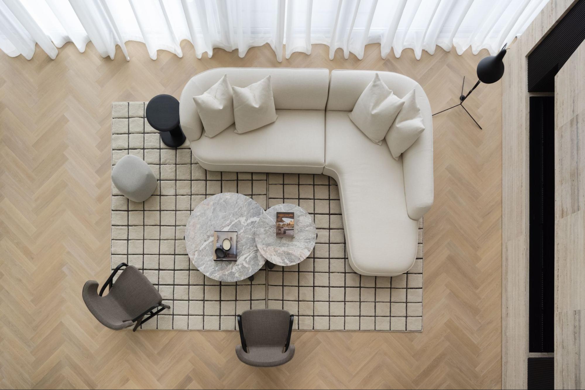 Scandinavian-inspired living room with reclaimed wood flooring, neutral tones, and timeless furniture design by Nordic Homeworx.