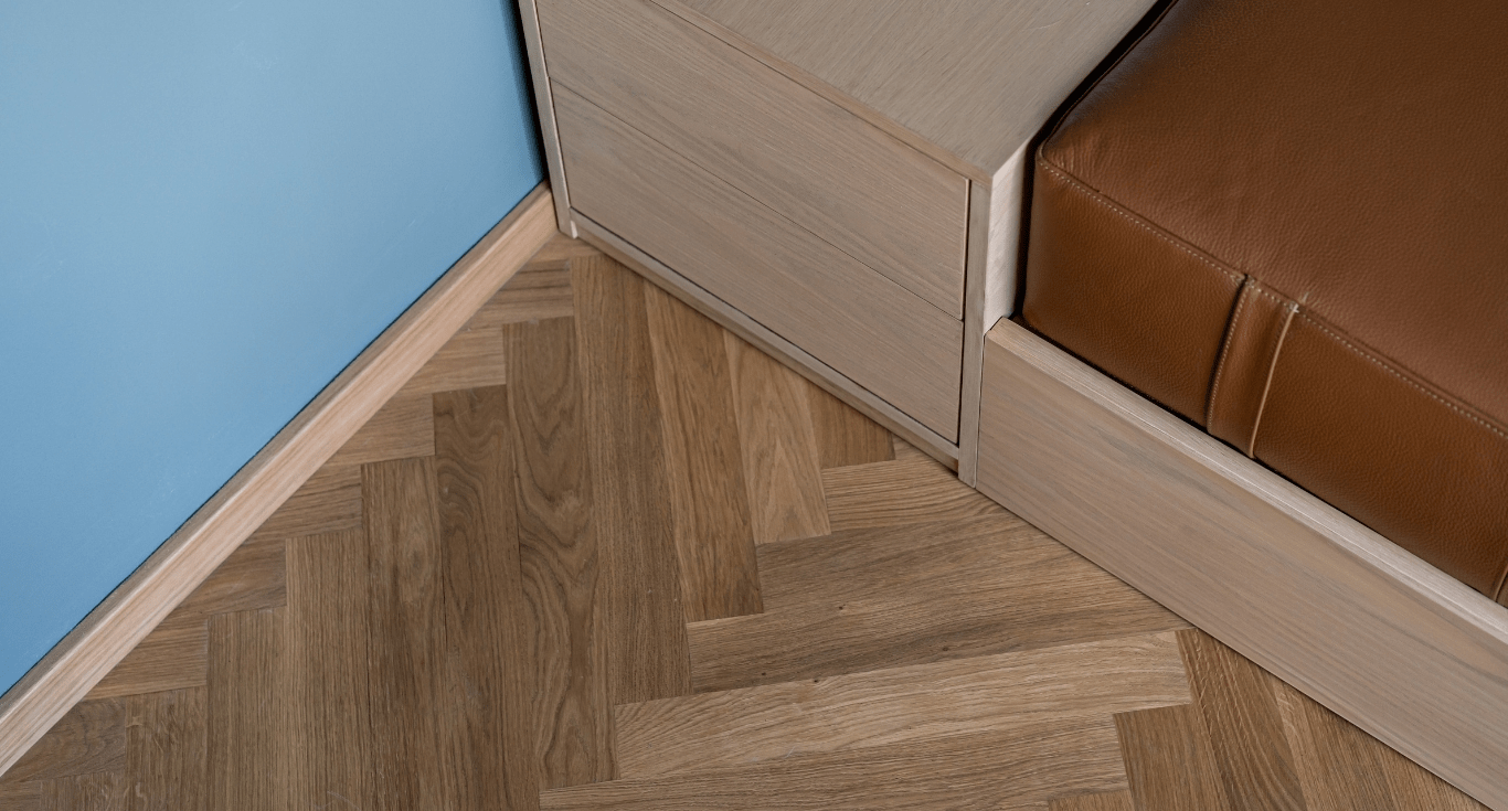 Detailed shot of parquet flooring restoration in Maeen Villa, Dubai, showcasing oak herringbone floors with natural texture