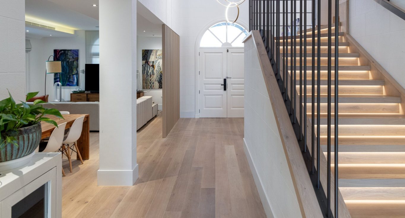 A villa entryway and staircase feature Kährs Oak Estoril, creating a classic, full-plank home flooring design by Nordic Homeworx.