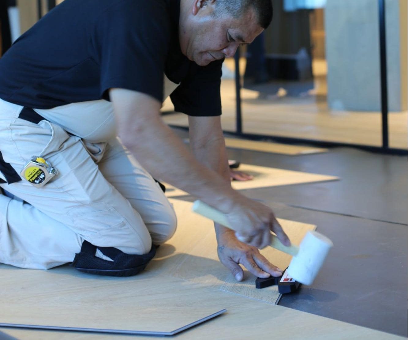 Nordic Homeworx expert installing wood planks, crafting a precise and seamless home flooring design for lasting style and comfort.