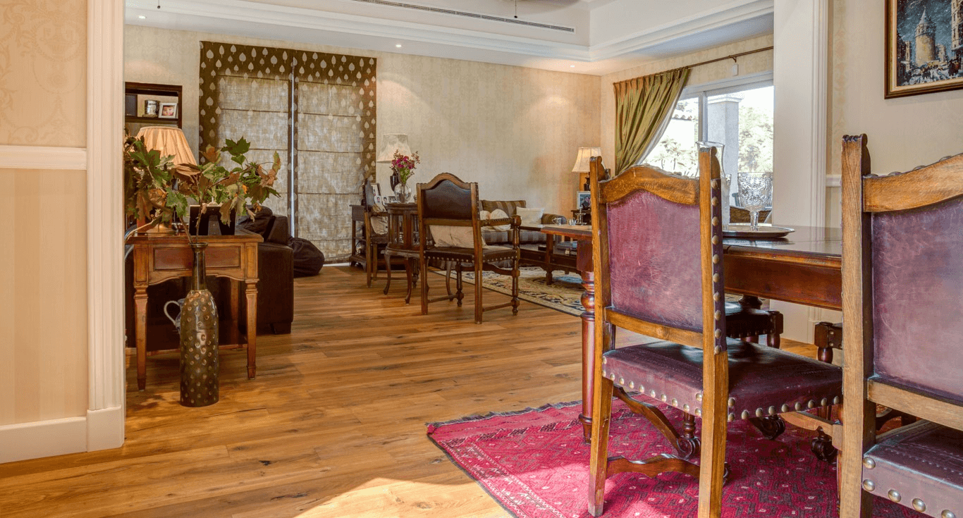 Cosy bungalow in Dubai, featuring brown Oak wood colour floors by Nordic Homeworx, paired with rustic furniture and antiquities.