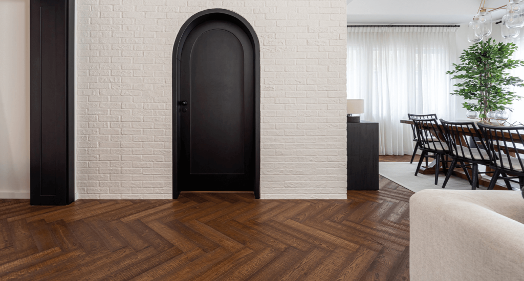 Herringbone flooring from Nordic Homeworx, in the living room at Alvorada Villa, adding warmth and texture with Dark wood colour.
