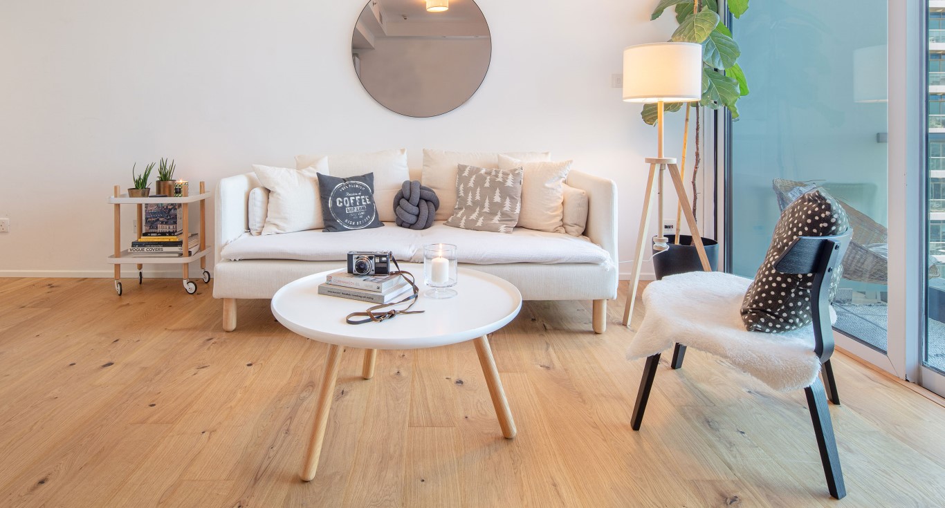 Minimalist wood flooring types define this apartment in Dubai, with rustic Kährs Oak Village flooring.