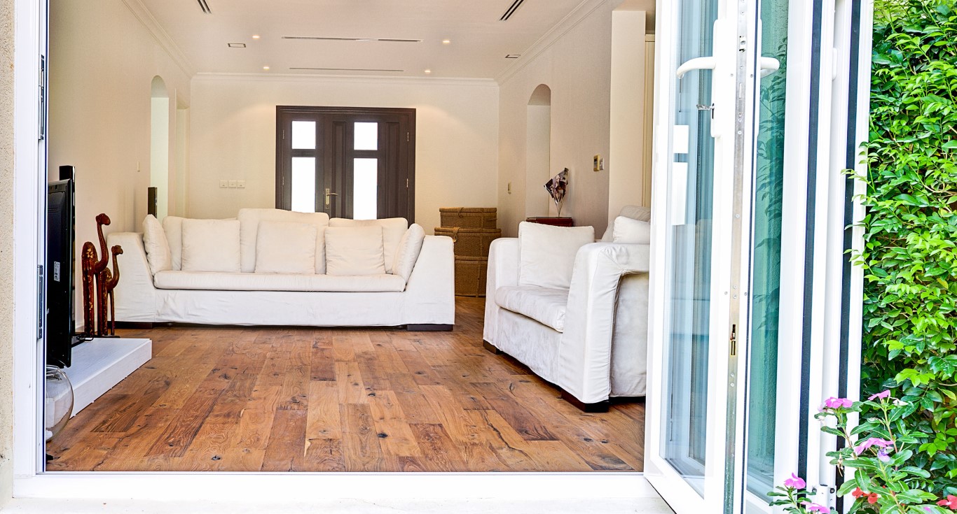 Teak wood colour featured in a family home in Dubai, with bright rustic interiors.