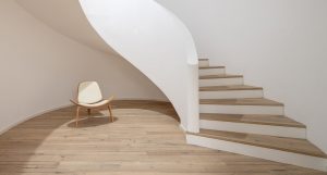 Oak Anziano flooring with a natural oil finish adding warmth beneath this sculptural staircase in The Lakes.