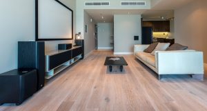 Oak Oyster flooring with subtle wood knot detail introduces a softer material contrast within the Elite Residence Apartment. 