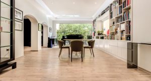 Wide-format hardwood flooring contributing to the bright interior of this Hattan family home. 